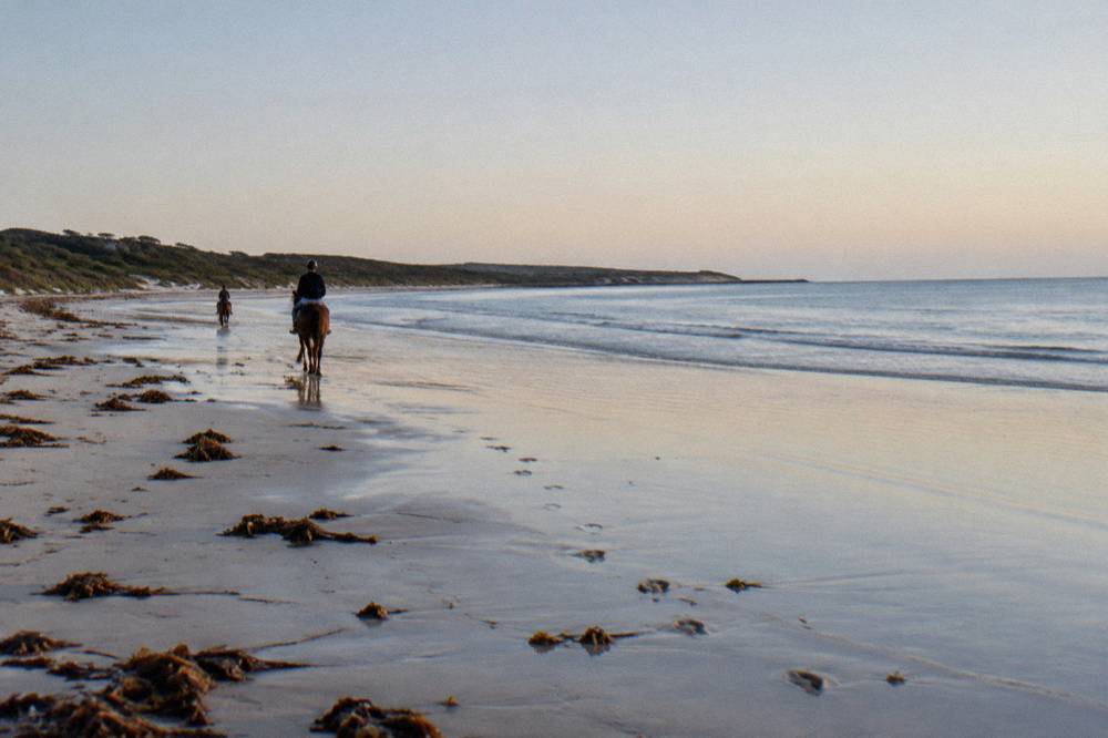 A calm sandy beach at Geographe Bay with shallow water and open sky