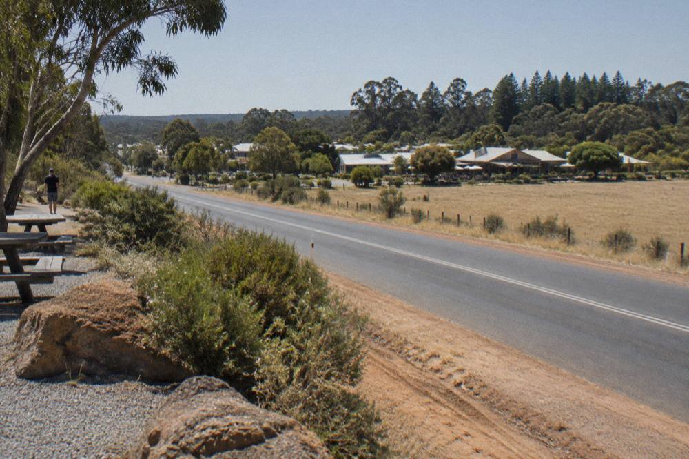 Open highway with farmland and distant trees on the drive south from Perth