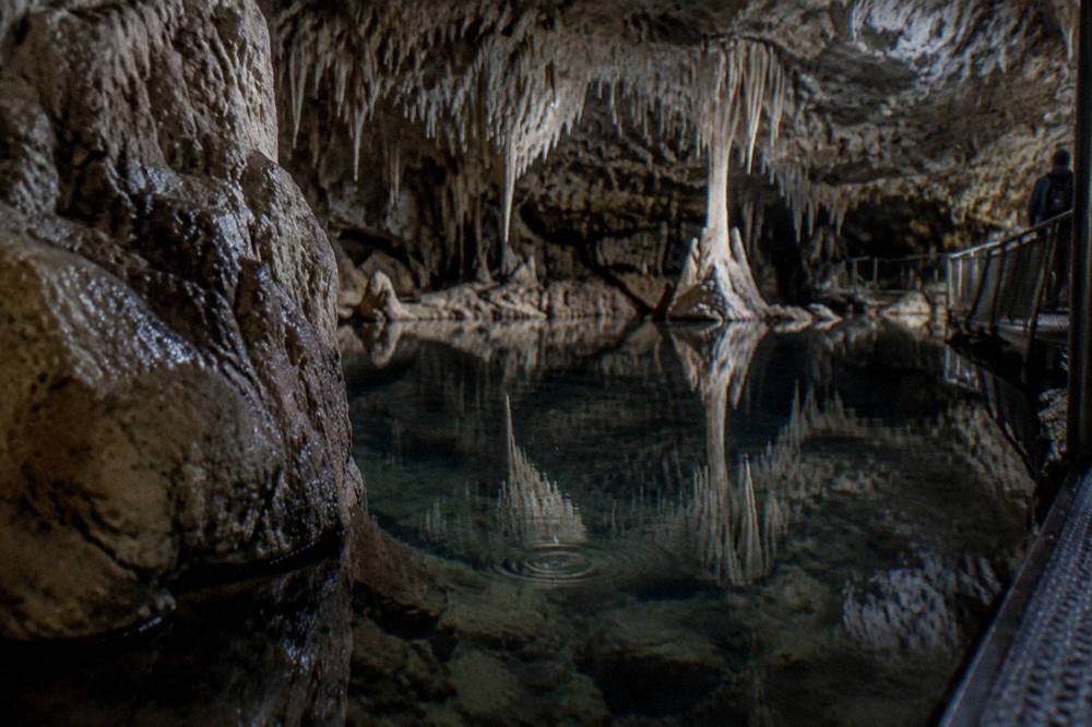 Limestone cave interior with boardwalk and still underground lake